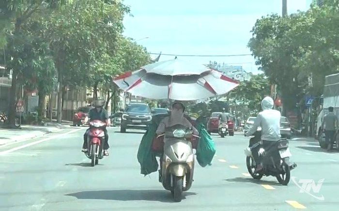 Xe máy gắn ô cỡ lớn không chỉ thêm cồng kềnh, chiếm không gian, gây khó khăn khi di chuyển mà còn tiềm ẩn nguy cơ mất an toàn giao thông.
