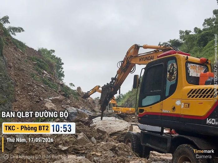 Máy xúc làm việc hết công suất để dọn đường cho người dân lưu thông an toàn.