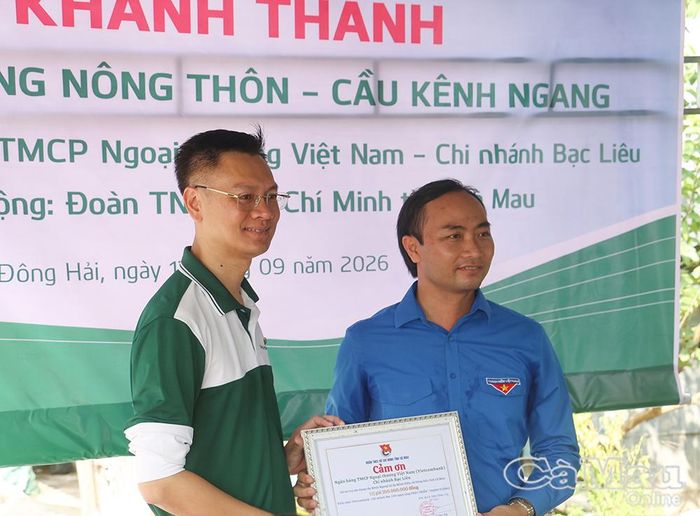  Đồng chí Phạm Tuấn Tài, Phó Chủ tịch Uỷ ban MTTQ Việt Nam tỉnh Cà Mau, Bí thư Tỉnh đoàn (bên phải), trao bảng cảm ơn đến ông Đậu Tuấn Cường, Giám đốc Vietcombank - Chi nhánh Bạc Liêu.