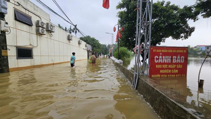 Nhiều tuyến đường dẫn vào khu dân cư vẫn chìm trong nước. Ảnh: TIẾN CƯỜNG