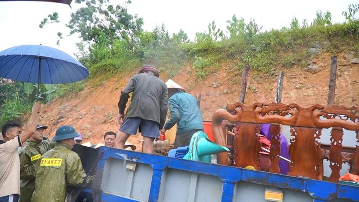 Lực lượng chức năng hỗ trợ người dân di dời tài sản ra khỏi khu vực nguy cơ sạt lở
