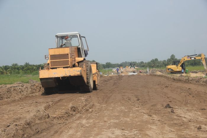 Xe lu, máy xúc cào bóc dọn dẹp mặt bằng thi công.