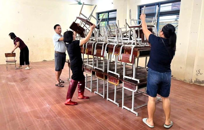 Cán bộ giáo viên tại các trường học, di chuyển bàn ghế học sinh lên cao.