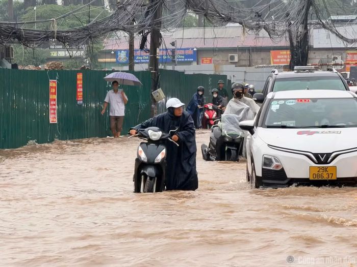 Nhiều người điều khiển xe phải giảm tốc độ, dò đường qua những đoạn nước sâu. Ảnh: Bảo Châu