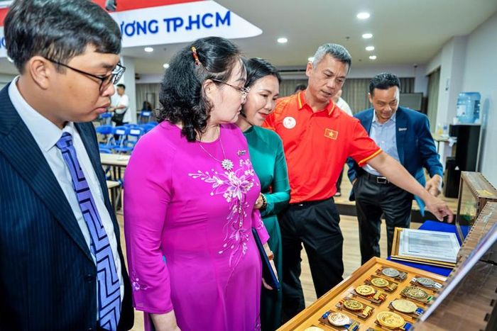 Đại biểu chiêm ngưỡng những tấm huy chương của võ sĩ Huỳnh Hà Hữu Hiếu.