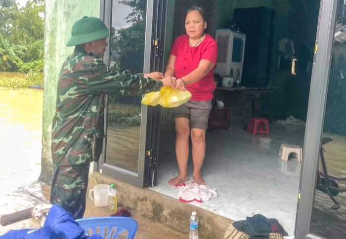 Những suất cơm nóng ấm lòng quân dân trong lũ lụt được đưa đến tay người dân.