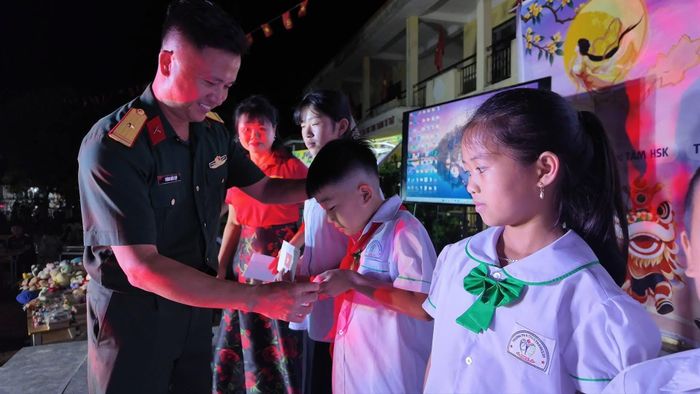 Đại diện chính quyền, lực lượng vũ trang và các nhà tài trợ trao quà Trung thu cho các em nhỏ.