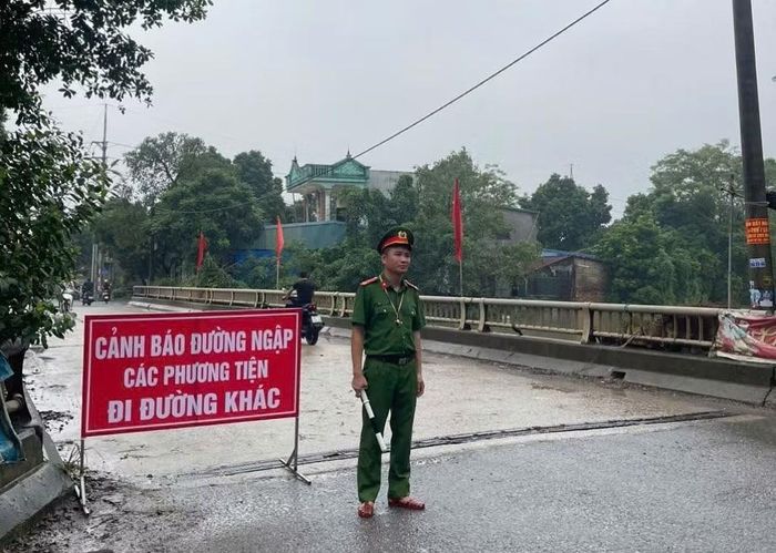 Hiện Công an xã Mỹ Đức duy trì các chốt phân luồng giao thông để cảnh báo người dân không đi vào vùng ngập lụt.