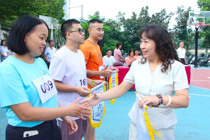 Phó Chủ tịch UBND phường Giảng Võ Lê Thị Thu Hà trao cờ lưu niệm cho các đội tham gia giải chạy. Ảnh: MH