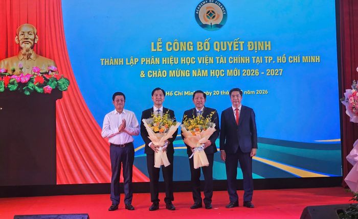 PGS-TS Nguyễn Đào Tùng - Giám đốc Học viện Tài chính (bìa phải) và ông Phạm Đức Thắng - Vụ trưởng Vụ Tổ chức cán bộ, Bộ Tài chính tặng hoa chúc mừng Ban Giám đốc Phân hiệu