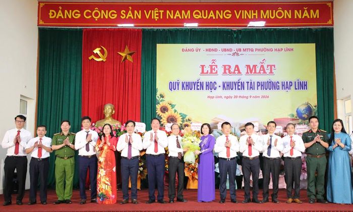 Đồng chí Trần Thị Hằng tặng hoa chúc mừng Ban điều hành Quỹ Khuyến học, Khuyến tài phường Hạp Lĩnh.