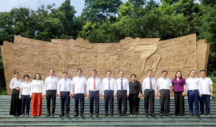 Đồng chí Trần Phong - Bí thư Tỉnh ủy Khánh Hòa cùng các đồng chí lãnh đạo tỉnh chụp ảnh lưu niệm tại Bức phù điêu "Bác Hồ nói chuyện với cán bộ, chiến sĩ Đại đoàn quân Tiên Phong" tại Ngã năm Đền Giếng.
