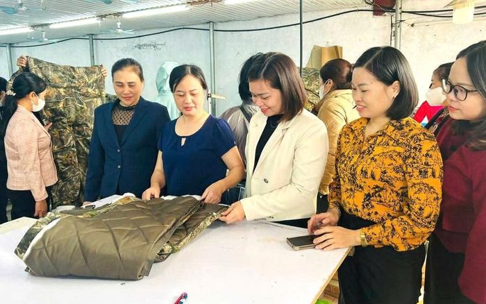 Từ khoản vay 100 triệu đồng, chị Nguyễn Thị Thêu (thứ 3 từ trái sang) mạnh dạn mở xưởng may, tạo việc làm và từng bước phát triển kinh tế gia đình