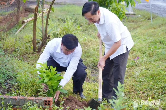 Thành ủy viên, Bí thư Đảng ủy, Chủ tịch HĐND xã Bom Bo Vũ Long Sơn (bên trái) và Phó Bí thư Đảng ủy, Chủ tịch UBND xã Bom Bo Nguyễn Văn Phát tham gia trồng cây sau buổi lễ. Ảnh: ĐVCC