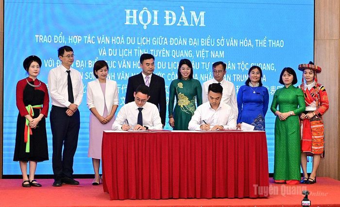 Các đại biểu chứng kiến doanh nghiệp của hai bên ký thỏa thuận hợp tác về du lịch, lữ hành.