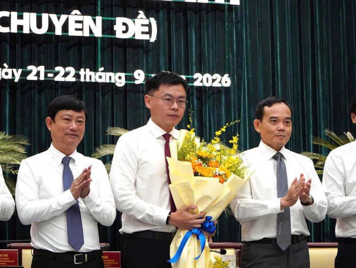 Tân Phó Chủ tịch UBND TP.HCM Trương Minh Huy Vũ nhận hoa chúc mừng từ Bí thư Thành ủy và Chủ tịch HĐND TP.HCM.