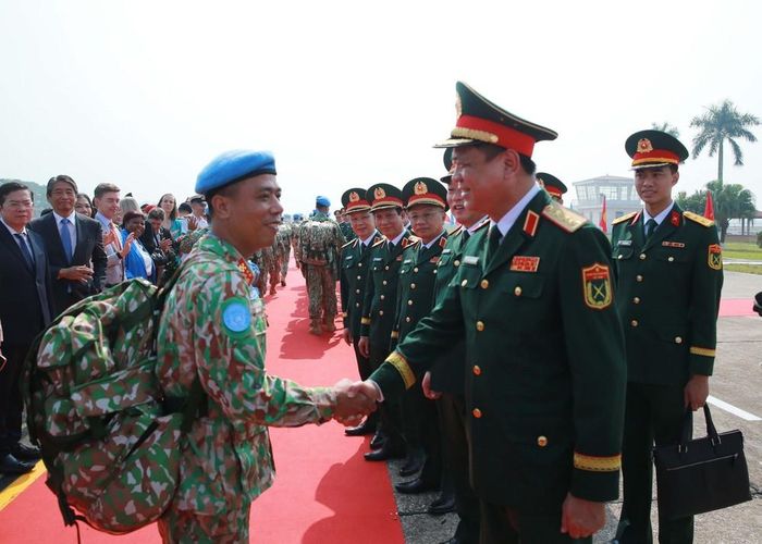 Các đồng chí lãnh đạo Bộ Quốc phòng chúc mừng, động viên các sĩ quan, quân nhân Bệnh viện dã chiến cấp 2 số 8 và Đội Công binh số 5 trong lễ xuất quân lên đường. Ảnh: Trọng Đức - TTXVN