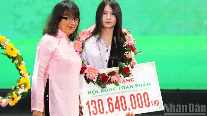 Tiến sĩ Nguyễn Thị Anh Đào, Hiệu trưởng nhà trường trao học bổng toàn phần cho sinh viên. (Ảnh: ANH ĐÀO)