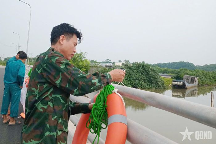 Cán bộ, nhân viên Ban CHQS phường Móng Cái 3 bố trí áo phao trên cầu, sẵn sàng phục vụ công tác tìm kiếm, cứu nạn.