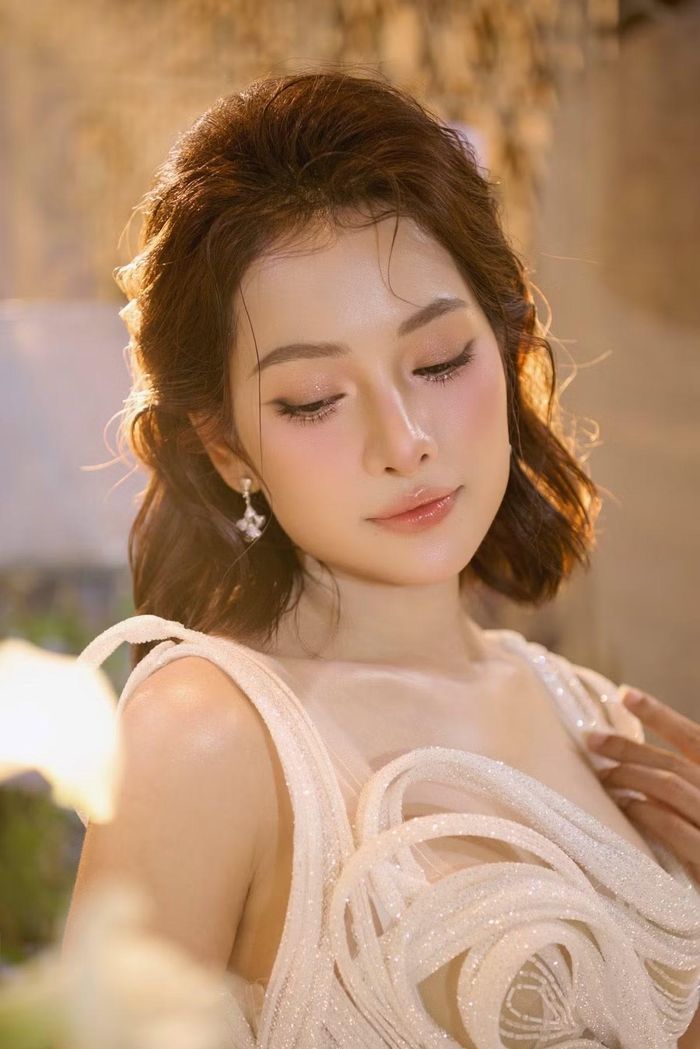 Ở góc chụp cận, bà xã Dương Khắc Linh khoe làn da mịn màng cùng đường nét gương mặt trẻ trung. Lối trang điểm tông hồng, mái tóc uốn nhẹ và khuyên tai nhỏ giúp cô thêm phần cuốn hút. Ảnh: FB Lưu Ngọc Duyên.
