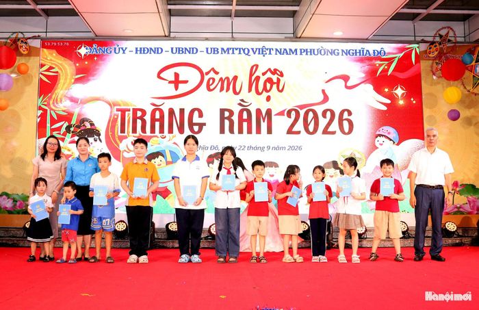 Bí thư Đảng ủy phường Nghĩa Đô Nguyễn Hồng Sơn và lãnh đạo Đảng ủy, MTTQ tặng quà cho các em thiếu nhi. Ảnh: MT