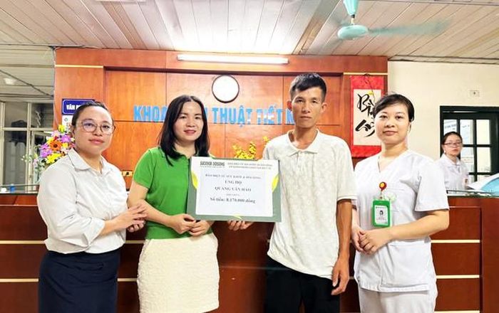 Anh Bạc Cầm Thông thay mặt anh Hảo nhận số tiền hỗ trợ của bạn đọc hảo tâm Báo Sức khỏe và Đời sống gửi tặng
