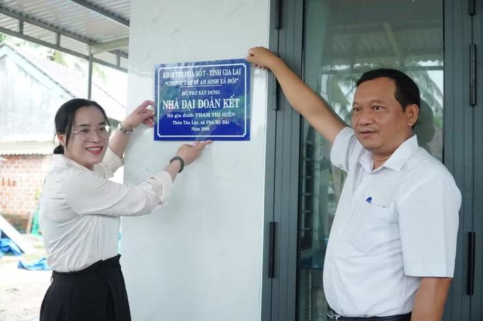 Phó Bí thư Thường trực Đảng ủy xã Lê Thị Tú và ông Lê Xuân Nguyên bàn giao nhà cho gia đình.