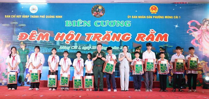 Thượng tá Lê Quang Chiểu, Phó Chính ủy Ban Chỉ huy Bộ đội Biên phòng thành phố Quảng Ninh và bà Nguyễn Thị Hiền, Bí thư Đảng ủy phường Móng Cái 1 trao quà tới các em học sinh.