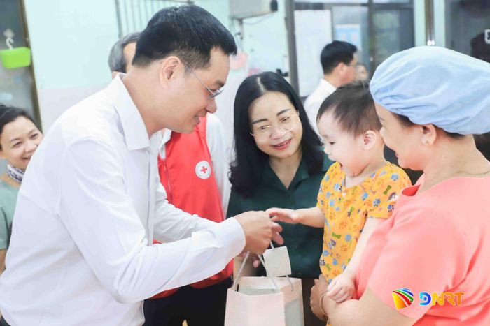 Bí thư Thành ủy Lê Ngọc Quang tặng quà cho các cháu thiếu nhi đang được nuôi dạy tại Trung tâm Nuôi dạy trẻ mồ côi thuộc Hội Chữ thập đỏ thành phố. Ảnh: NGỌC PHÚ