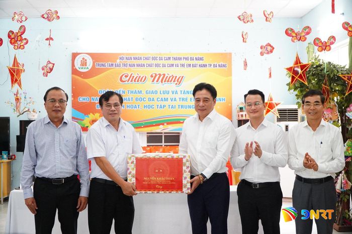 Phó Bí thư Thường trực Thành ủy Nguyễn Khắc Toàn (thứ 3, bên phải sang) trao quà cho lãnh đạo trung tâm. Ảnh: VINH ANH
