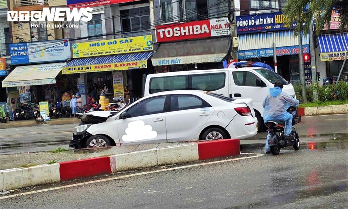 Xe taxi đang đậu gần đó bị va chạm hư hỏng nặng phần đầu.