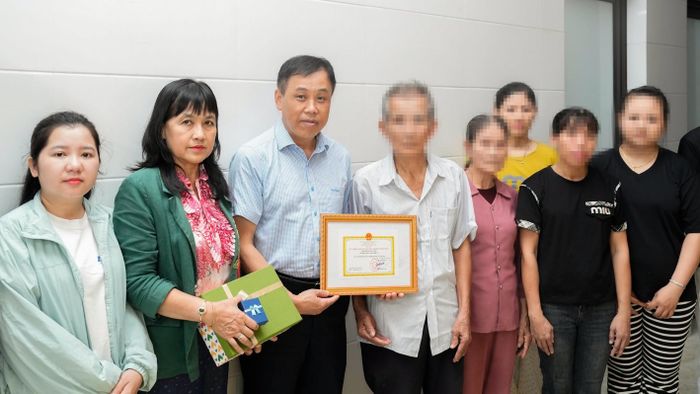 Lãnh đạo Bệnh viện Trung ương Huế trao kỷ niệm chương “Vì sức khoẻ nhân dân” của Bộ trưởng Bộ Y tế cho gia đình anh N. (Ảnh: BVCC)