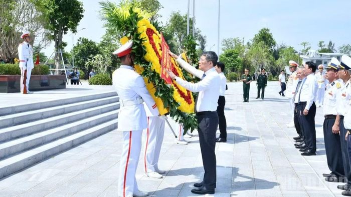 Thủ tướng Chính phủ Lê Minh Hưng thực hiện nghị thức chỉnh hoa, chuẩn bị vào dâng hương tại Đài tưởng niệm của Khu di tích quốc gia đặc biệt Bến K15. (Ảnh: THANH GIANG)