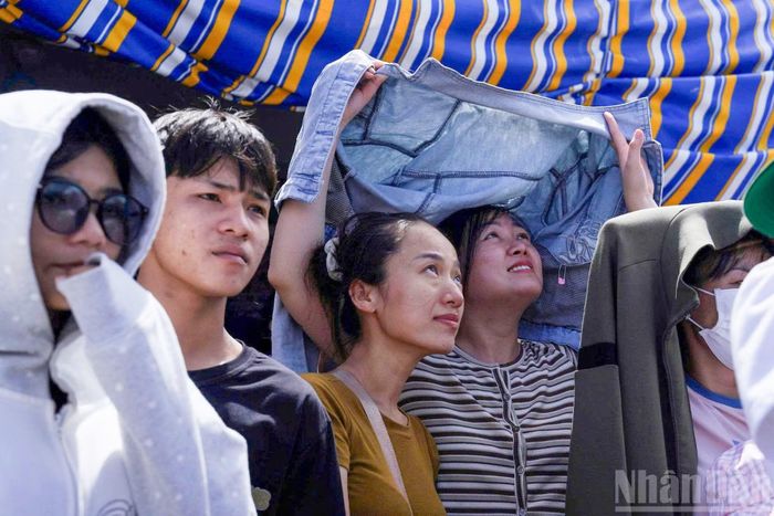  Nam, nữ thanh niên﻿ hòa mình vào không khí vui tươi, sôi nổi của lễ hội. 