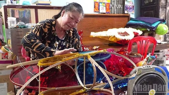 Bà Nguyễn Thị Ngọc Ngân làm đèn Trung thu. (Ảnh: HỮU NGHĨA)