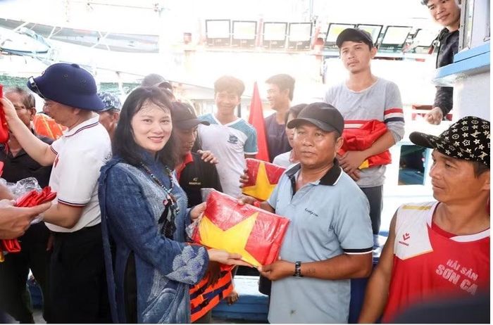 Phó Tổng Giám đốc Agribank Phùng Thị Bình - đại diện đoàn công tác Agribank trao cờ tặng ngư dân trên âu tàu tại Trường Sa. (Ảnh Agribank)