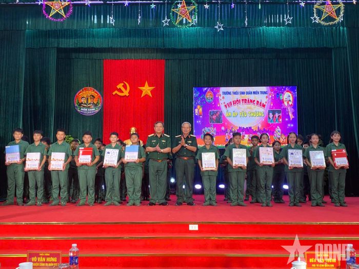    Thiếu tướng Hứa Văn Tưởng, Phó tư lệnh Quân khu 5 và Thiếu tướng Võ Văn Hưng, Chủ nhiệm Chính trị Quân khu 5 trao các suất quà tặng các em học sinh khối 6.