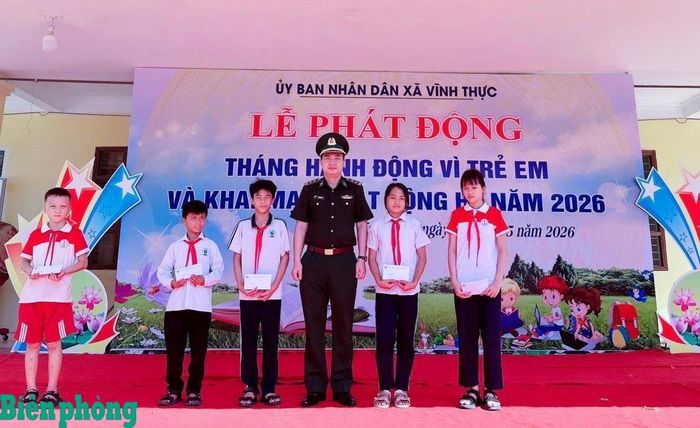 Cán bộ Đồn Biên phòng cửa khẩu cảng Vạn Gia trao học bổng, động viên học sinh có hoàn cảnh khó khăn trên địa bàn xã Vĩnh Thực. Ảnh: Ngọc Châu