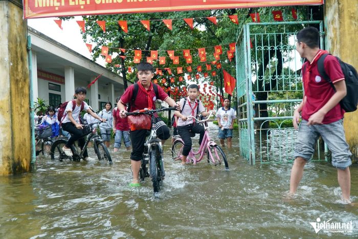 Nhiều phụ huynh lo con đi học trong điều kiện ngập nước có thể đối mặt với nguy cơ tai nạn. Ảnh: Lê Dương