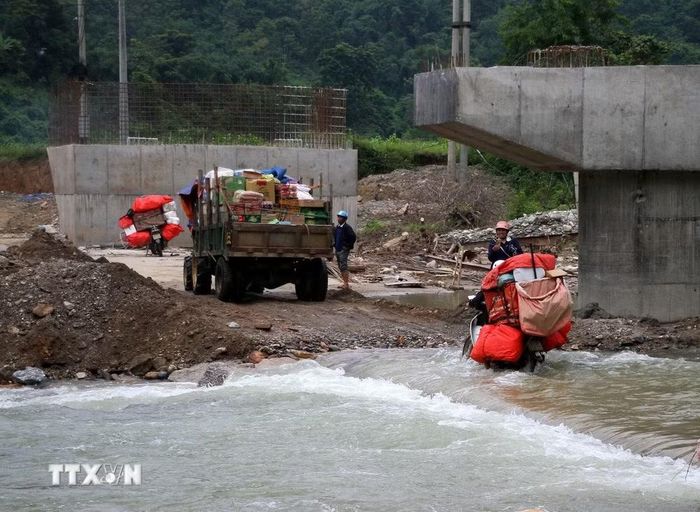 Việc đi lại của người dân khi qua các tràn trên tỉnh lộ 541B vẫn gặp nhiều khó khăn. (Ảnh: Văn Tý/TTXVN)