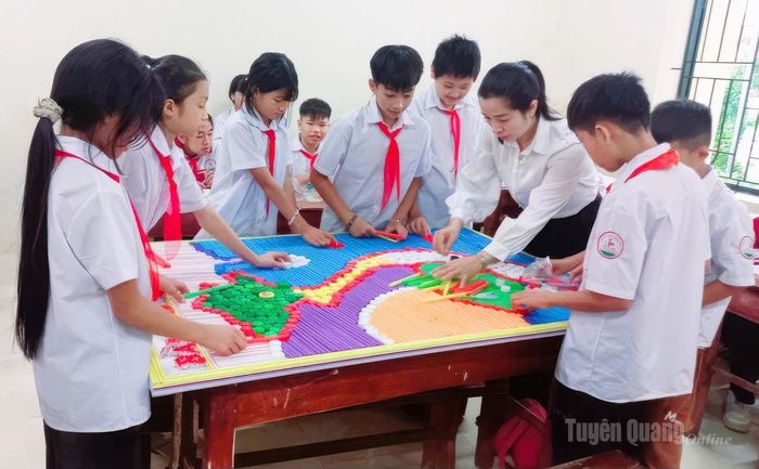 Học sinh Trường THCS Đồng Yên tham gia hoạt động trải nghiệm ghép tranh bằng nắp chai và ống hút nước đã qua sử dụng, nhằm nâng cao nhận thức bảo vệ môi trường.