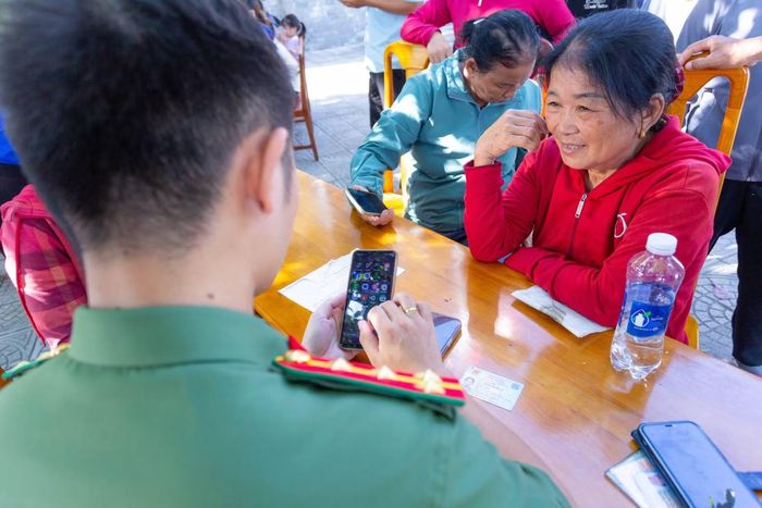 Niềm vui của người dân khi được cán bộ, chiến sĩ Công an xã Bố Trạch, Công an tỉnh Quảng Trị hướng dẫn, hỗ trợ về chuyển đổi số.