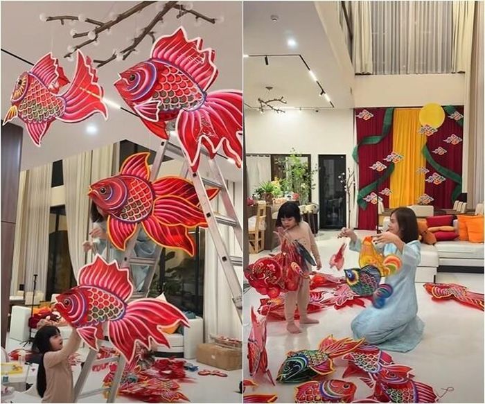 Không gian phòng khách biến thành một "xưởng sản xuất" lồng đèn thu nhỏ với hàng chục chiếc đèn cá chép, đèn bướm đủ màu sắc. Vân Trang vừa miệt mài treo đèn lên cao, vừa kiên nhẫn hướng dẫn các con xếp từng chiếc lồng đèn, tạo nên một bầu không khí chuẩn bị Tết Trung thu rộn rã, tràn ngập tiếng cười.
