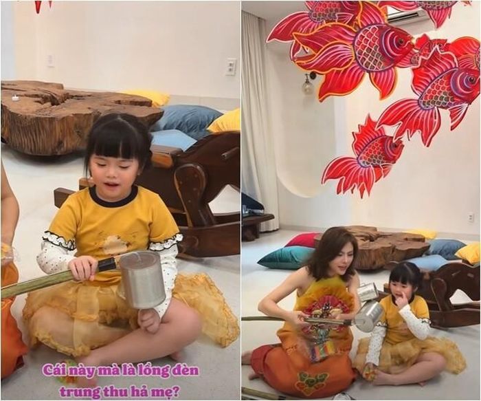 Không gian bếp tràn ngập không khí Tết Trung thu với dàn đèn ông sao, đèn cá chép rực rỡ treo cao. Vân Trang rạng rỡ diện áo dài sắc cam - vàng đồng điệu bên con trai nhỏ, tạo nên khoảnh khắc vô cùng ấm áp và bình yên trong chính ngôi nhà của mình.