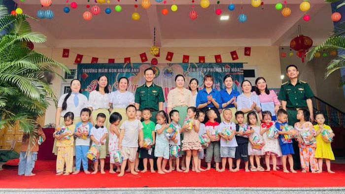 Đại diện Trường mầm non Hoàng Anh và Đồn Biên phòng Tuy Hòa trao quà tặng các em thiếu nhi. (Ảnh: NGỌC LÂN)