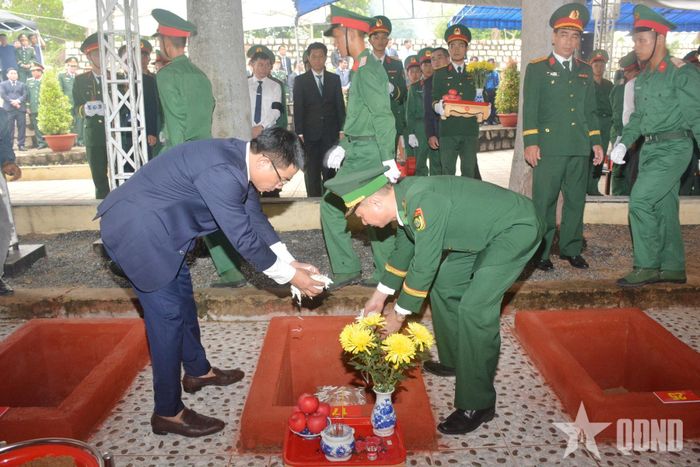  Các đại biểu thả hoa vào phần mộ vừa an táng.