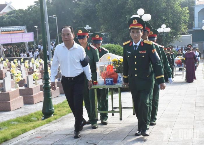  Đại biểu thực hiện nghi lễ di chuyển hài cốt ra vị trí an táng.  