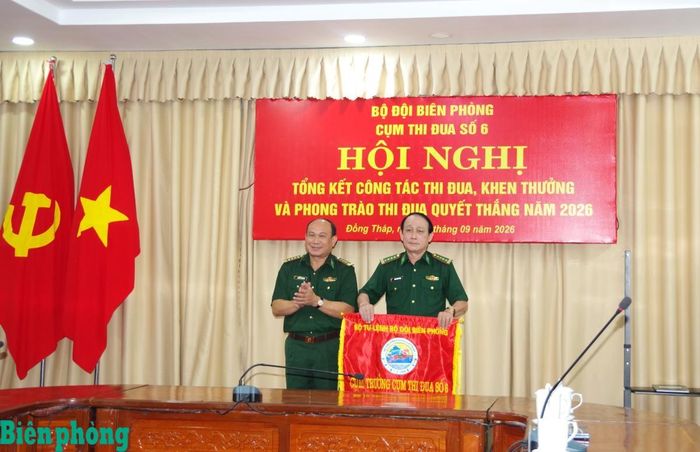 Đại tá Nguyễn Văn Minh, Chính ủy Bộ đội Biên phòng tỉnh Đồng Tháp (bên trái) trao cờ luân lưu Cụm trưởng năm 2027 cho Đại tá Đoàn Minh Trung, Chỉ huy trưởng Bộ đội Biên phòng tỉnh Vĩnh Long. Ảnh: Lê Khoa