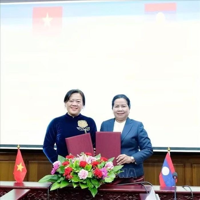 Đồng chí Y Thị Bích Thọ và đồng chí Vatsana Silima ký biên bản hợp tác giữa hai địa phương. Ảnh: Xuân Tú/PV TTXVN tại Lào