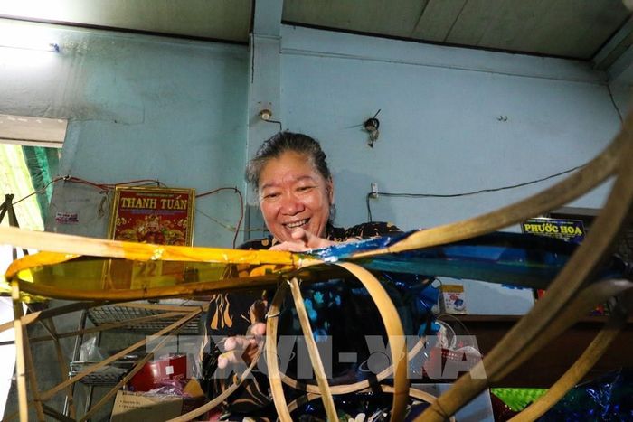 Với bà Ngân, tạo ra những chiếc lồng đèn thủ công là niềm vui mỗi dịp Tết Trung thu. Ảnh: Hồng Thái - TTXVN